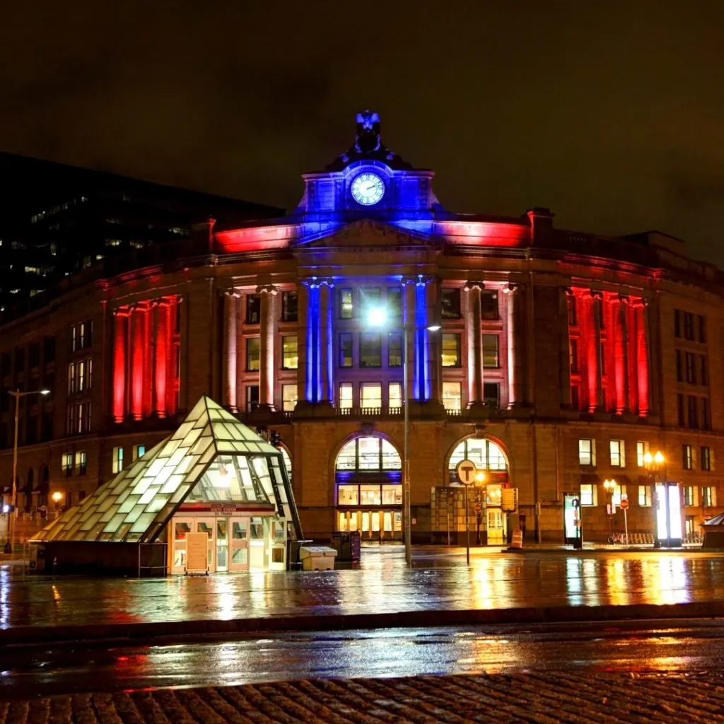 Photo of the main entrance to Boston's South Station train depot at night.