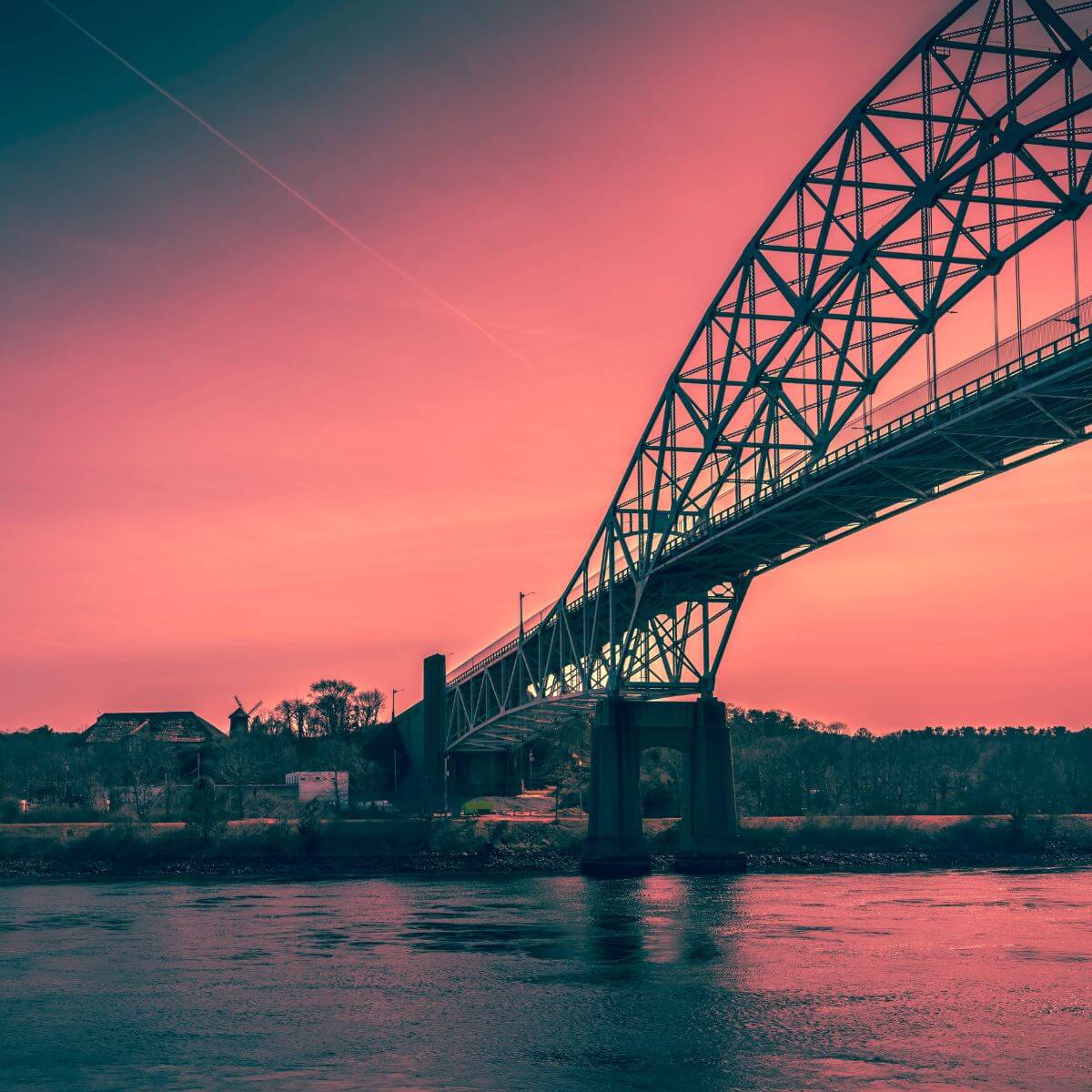 Photo of the Sagamore Bridge at sunset with a red sky.