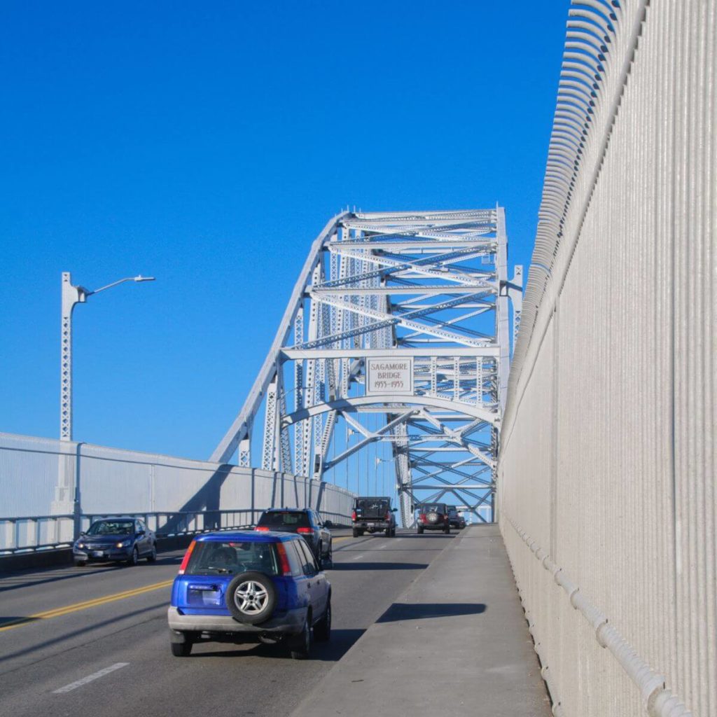 Photo of cars driving over the Sagamore Bridge to Cape Cod.