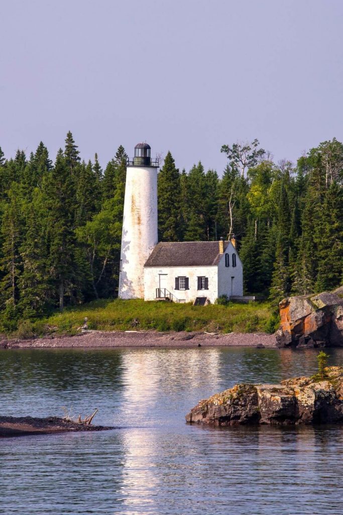 Photo of a small lighthouse on rocky shoreline at Isle Royale National Park in Michigan