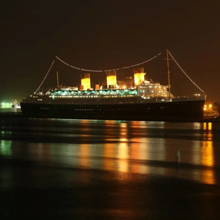 Photo of the RMS Queen Mary Ocean Liner in Long Beach, California, at night.
