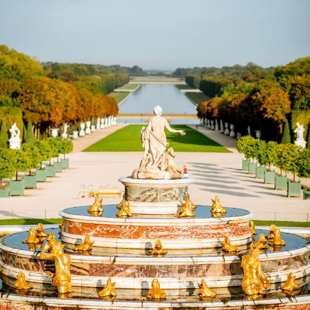 Photo of a gilded fountain in the gardens at the Palace of Versailles