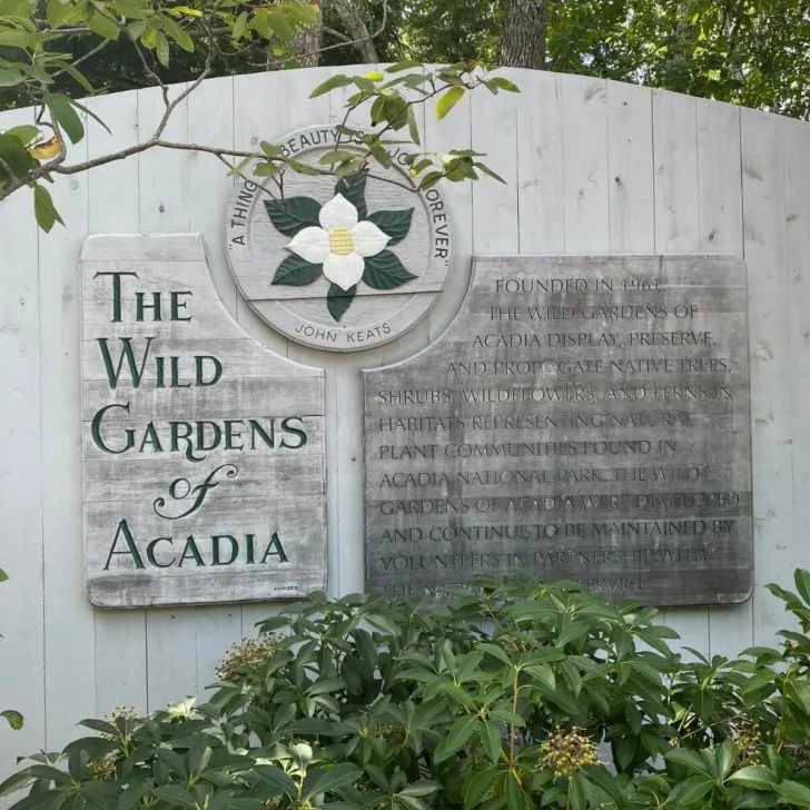 Photo of a large wooden sign for The Wild Gardens of Acadia.