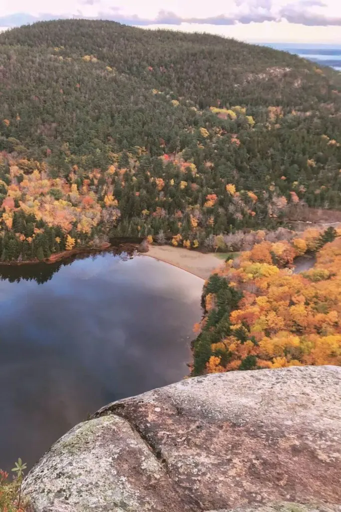 Photo of the view looking over Echo Lake from Beech Cliff Trail with Fall foliage in the background.