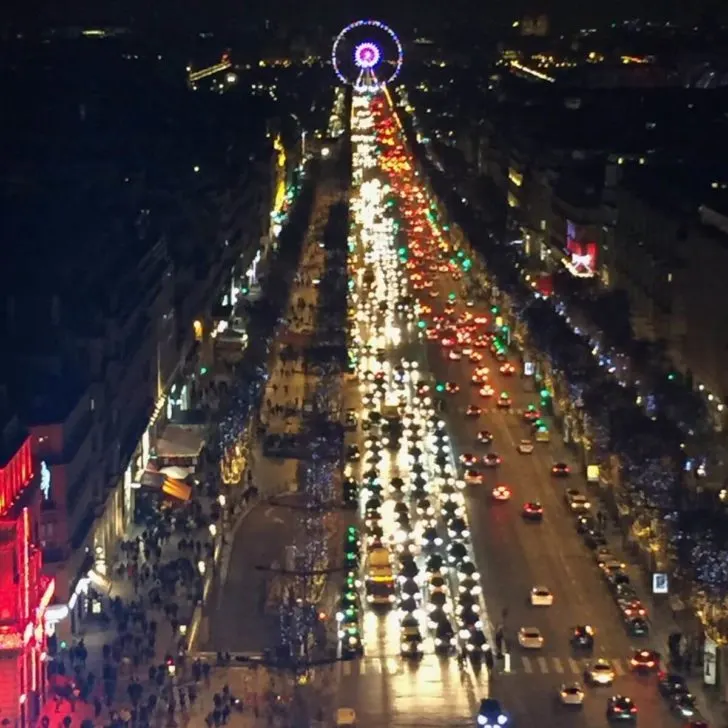 Photo of Champs-Elysees from the Arc de Triomphe in Paris at night.
