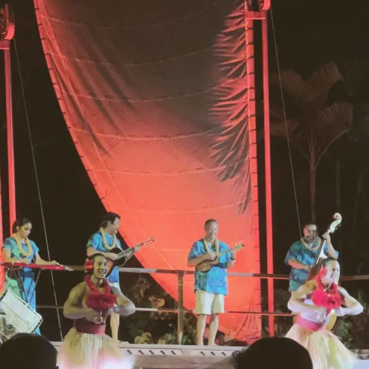 Photo of musicians and dancers performing in a luau at Aulani Resort.