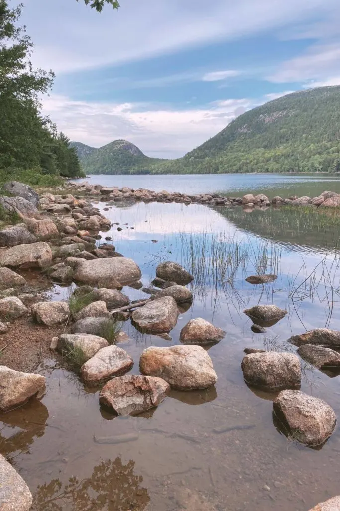 Photo of Jordan Pond with the Bubble Mountains reflecting in the water.