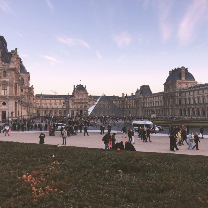 Photo of the Louvre Museum, including the Pyramids, from across the street.