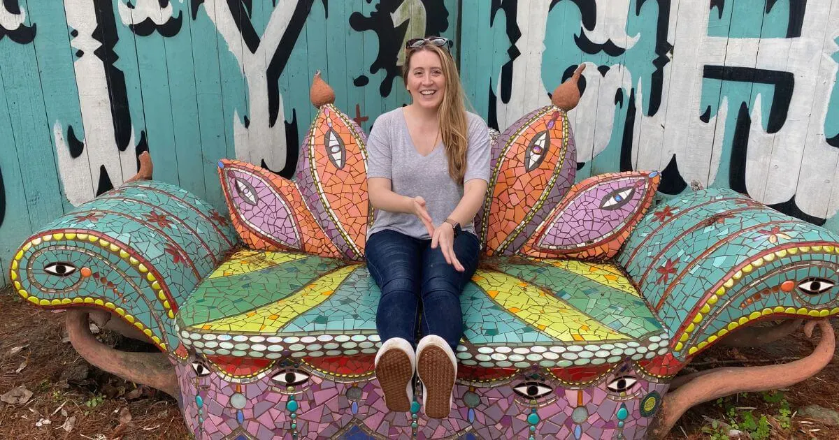 Photo of a woman sitting on a colorful mosaic-tiled couch in New Orleans, LA.