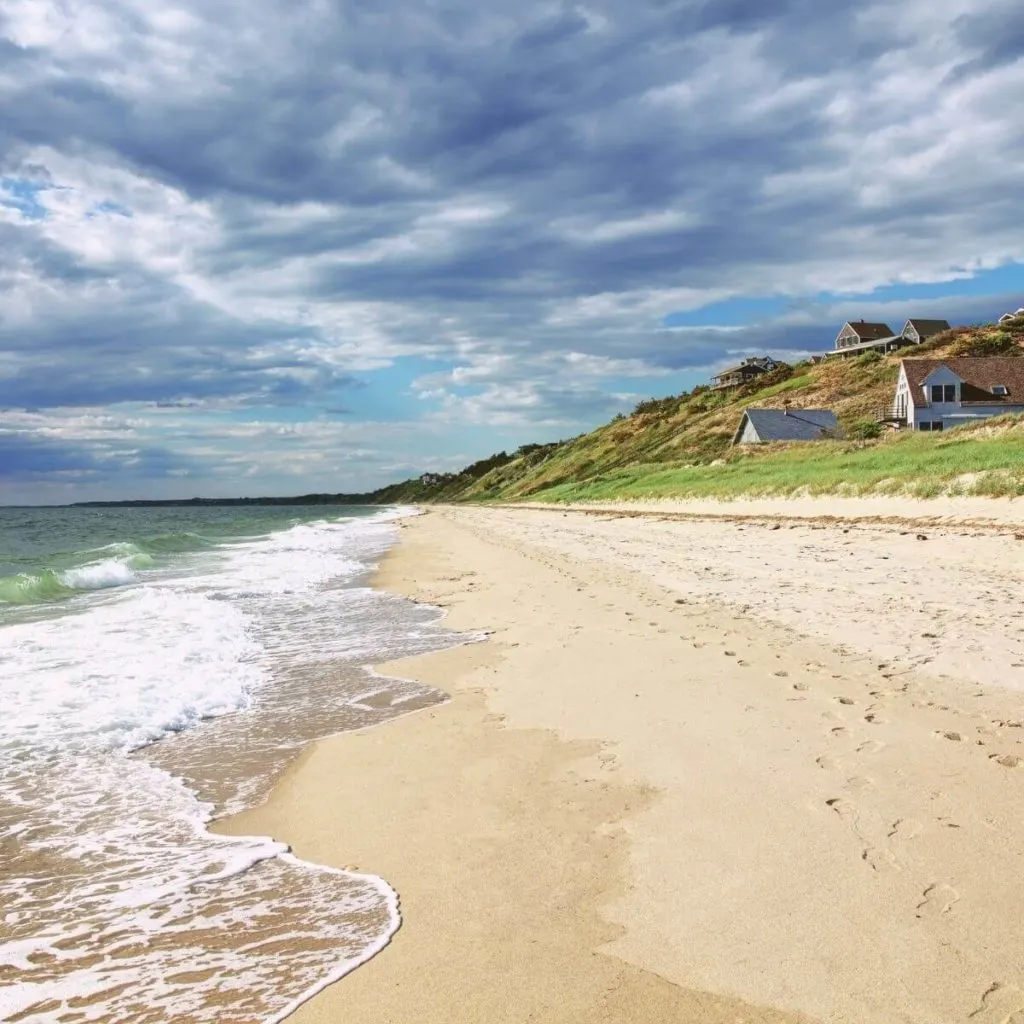 Photo of Corn Hill Beach in Truro in the Outer Cape with beach cottages in the distance.