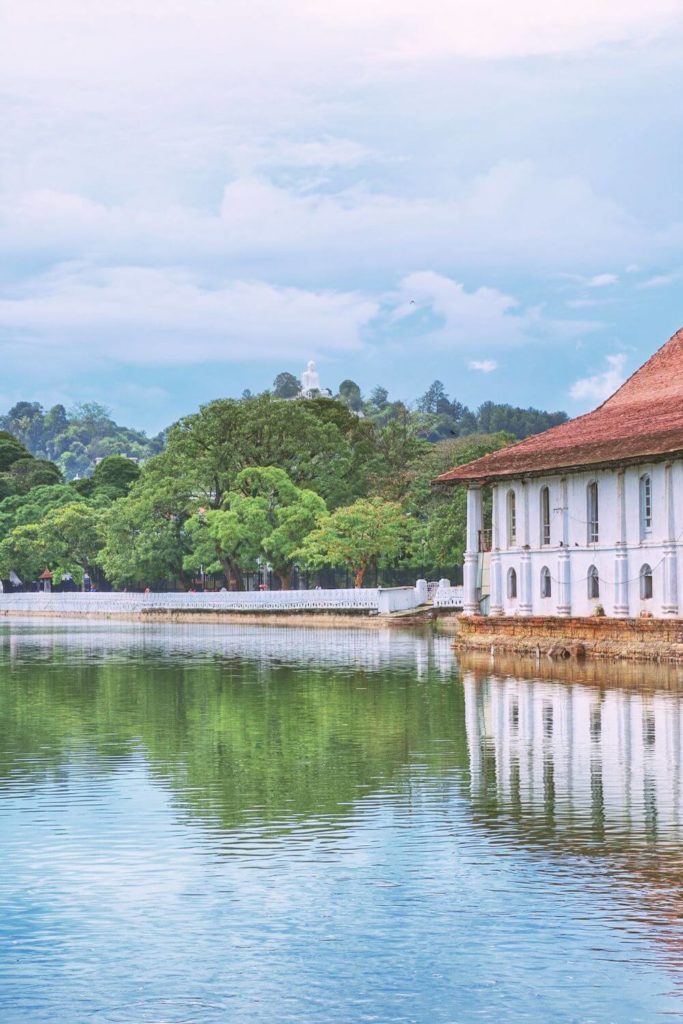 Photo of Kandy Lake in Sri Lanka with a building reflecting in the water.
