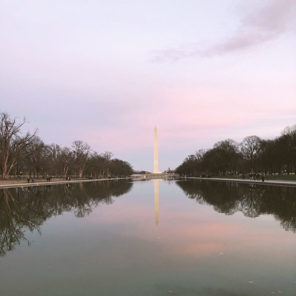 Photo of the Washington Monument reflecting in the Reflecting Pool during sunset.