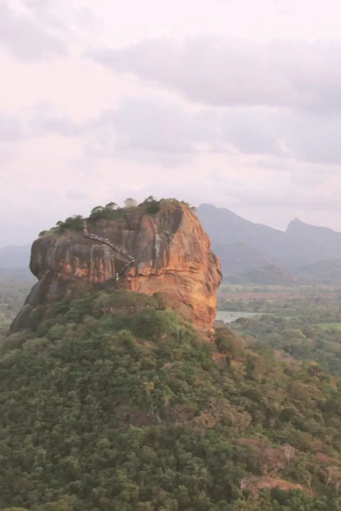 Photo of Sigiriya with people lining up the side from the top of Pidurangala Rock.