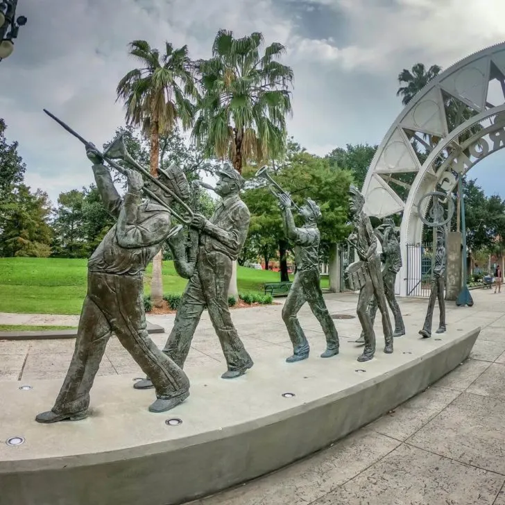 Photo of a sculpture of musicians playing Jazz instruments nearby the main entrance to Armstrong Park, where the first Jazz Fest was held in New Orleans.