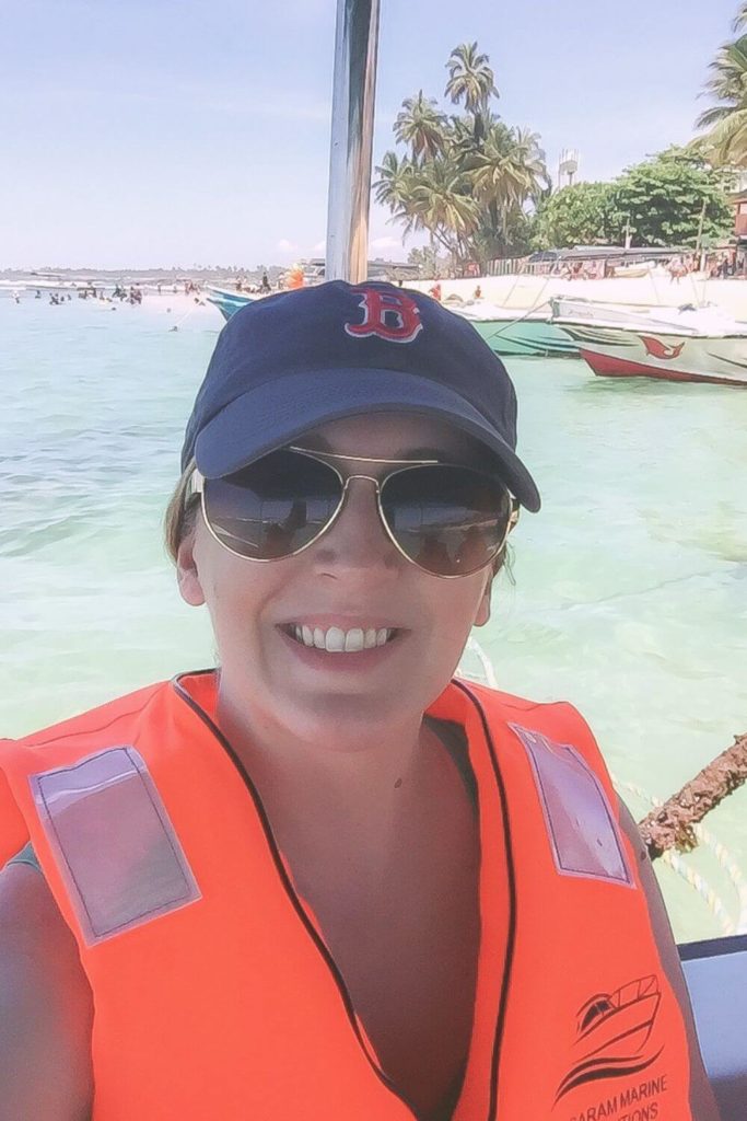 Photo of a woman wearing a life vest on a boat off the coast of Sri Lanka.