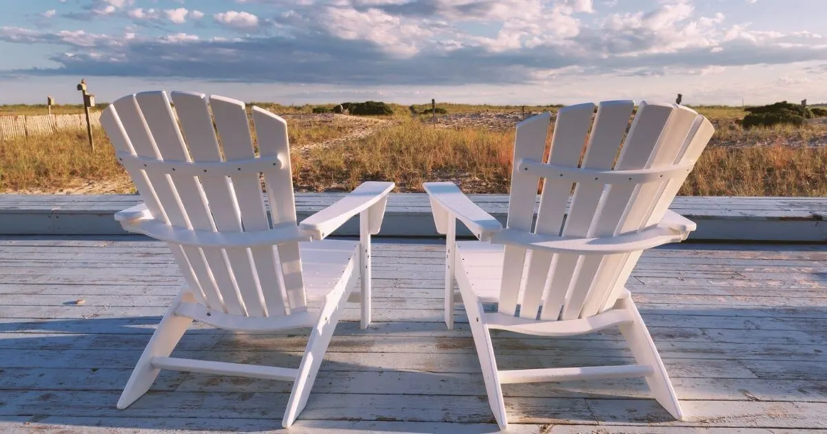 Photo of 2 Adirondack chairs overlooking a beach in Cape Cod, Massachusetts.
