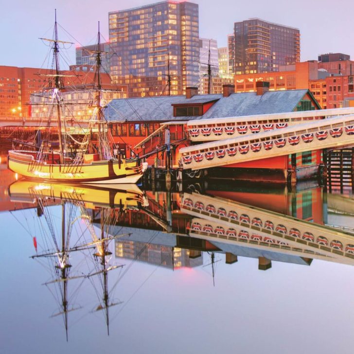 Photo of the Boston Tea Party Ship replica, reflecting in the harbor's water.