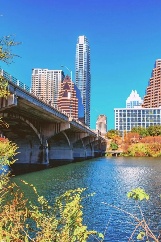 Photo of downtown Austin Texas from the Colorado River with the Congress Ave Bridge and the city skyline in the background.