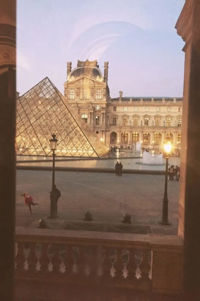 Photo of the Louvre museum and pyramid from inside one of the museum wings.