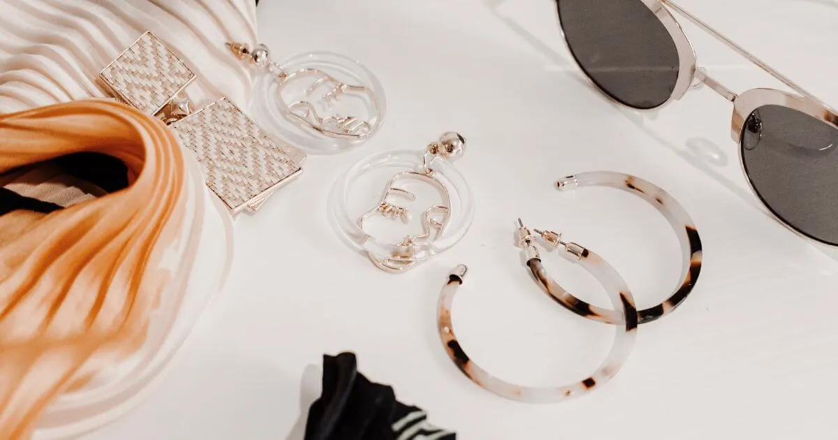 Flat lay photo of southwestern and boho inspired jewelry and sunglasses.