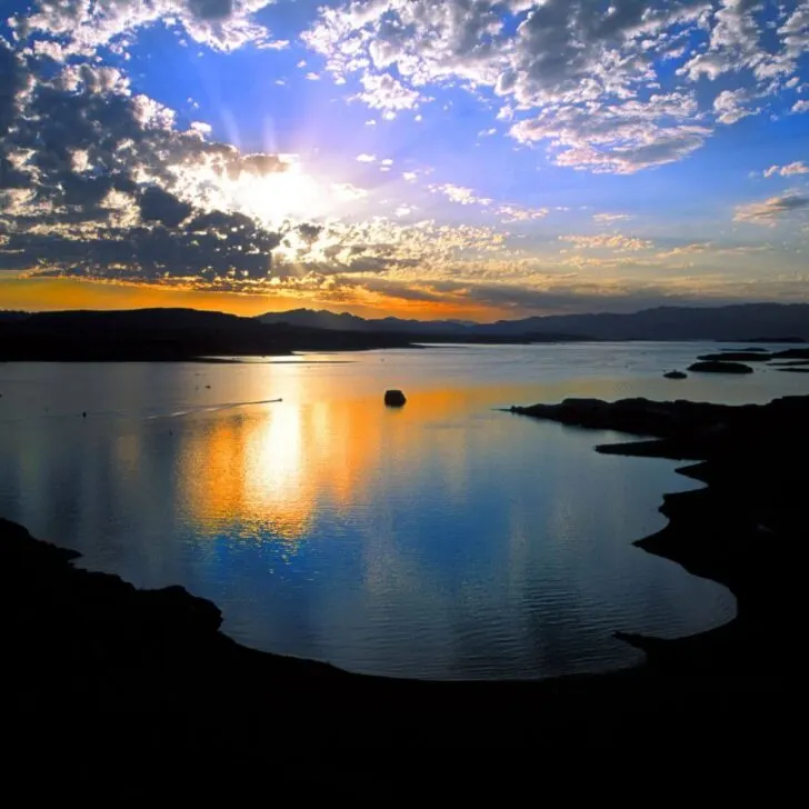 Photo of Lake Mead at sunset with the sky reflecting in the water.