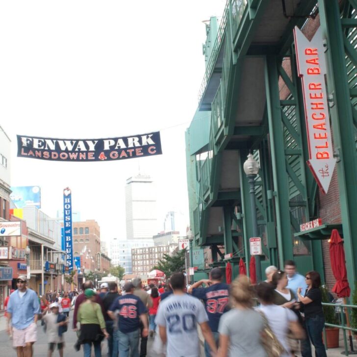 Photo of a crowd of Yankees and Red Sox fan walking outside Fenway Park in Boston near Gate C.