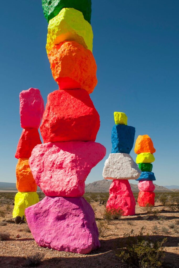 Vertical photo of the Seven Magic Mountains art installation outside of Las Vegas.