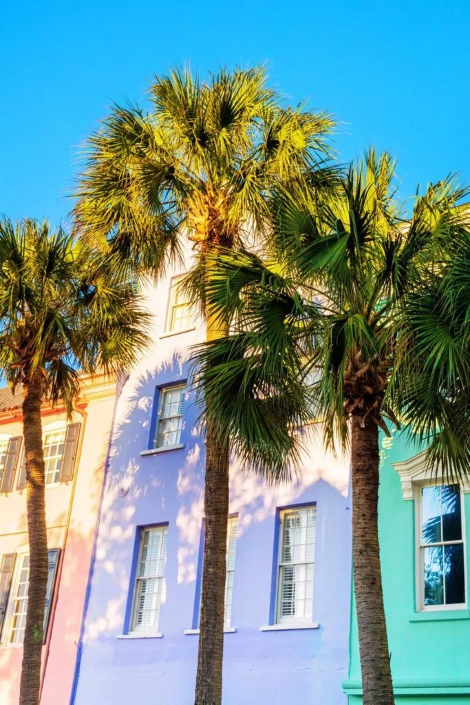 Photo of colorful buildings in Charleston, South Carolina, with palm trees in front.