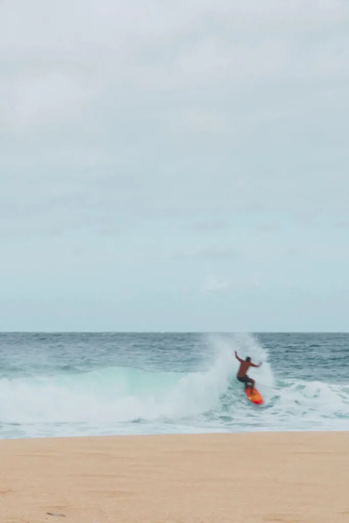 Photo of a man surfing in North Shore, Oahu, Hawaii.