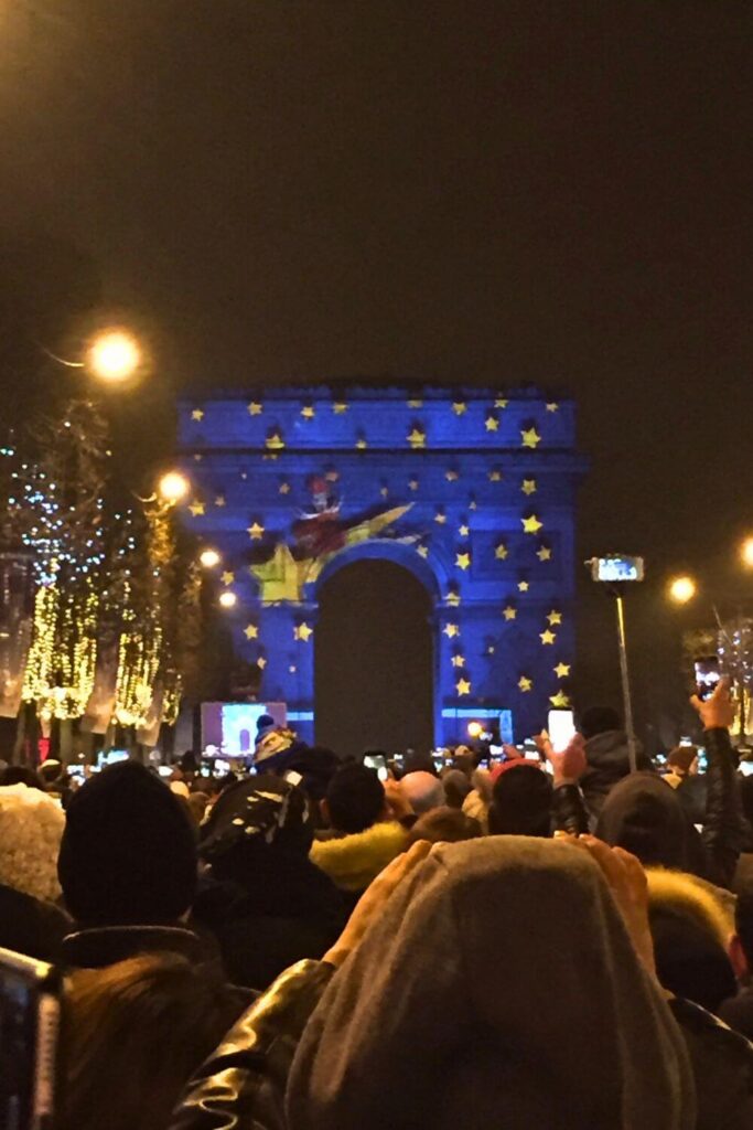 Photo of the Arc de Triomph in Paris, France with a projection show in progress on New Year's Eve.