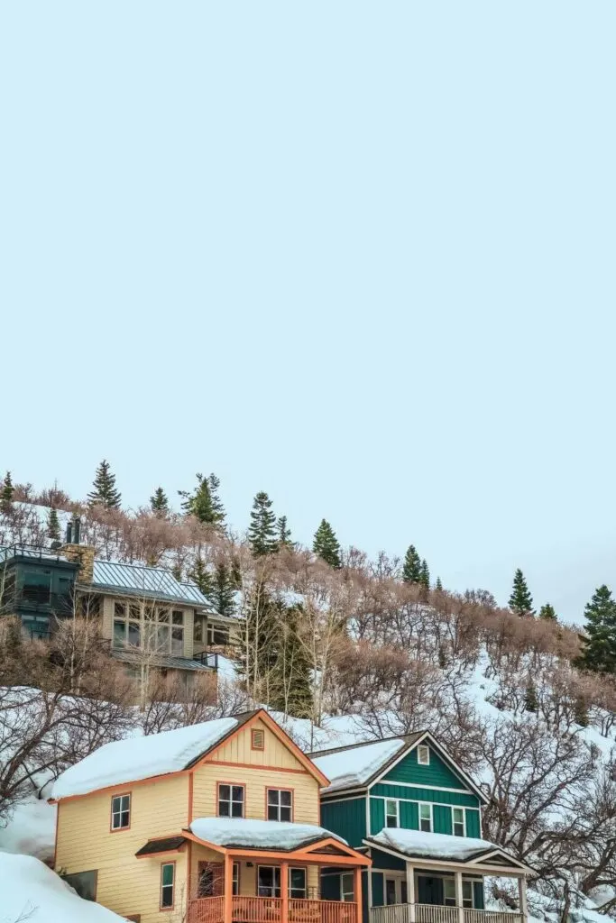 Photo of quaint ski homes in Park City, Utah, with snow on the ground.