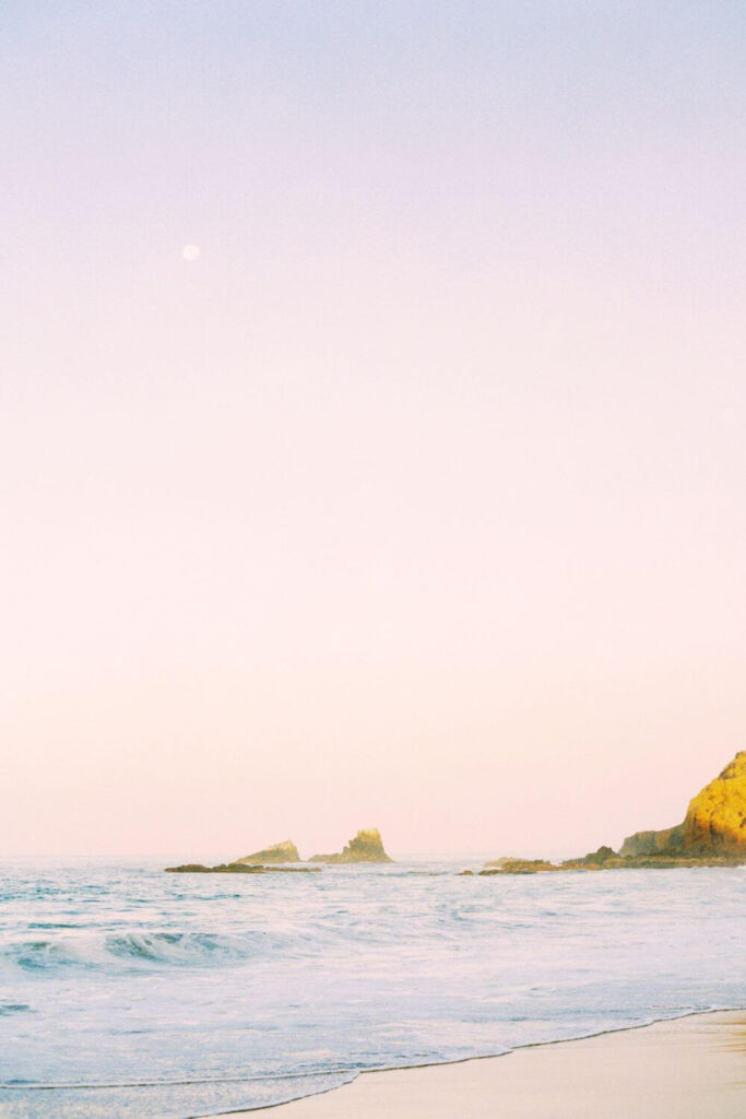 Photo of an ocean landscape with rocks in the distance.