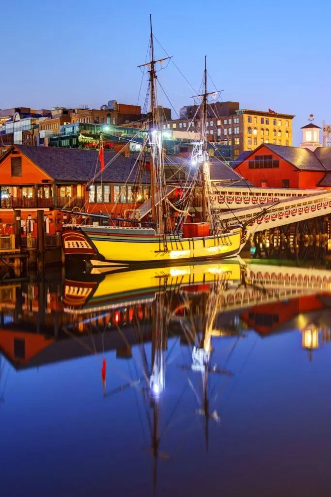 Photo of the Boston Tea Party Ship & Museum in the early evening, with the ship reflecting in the water.