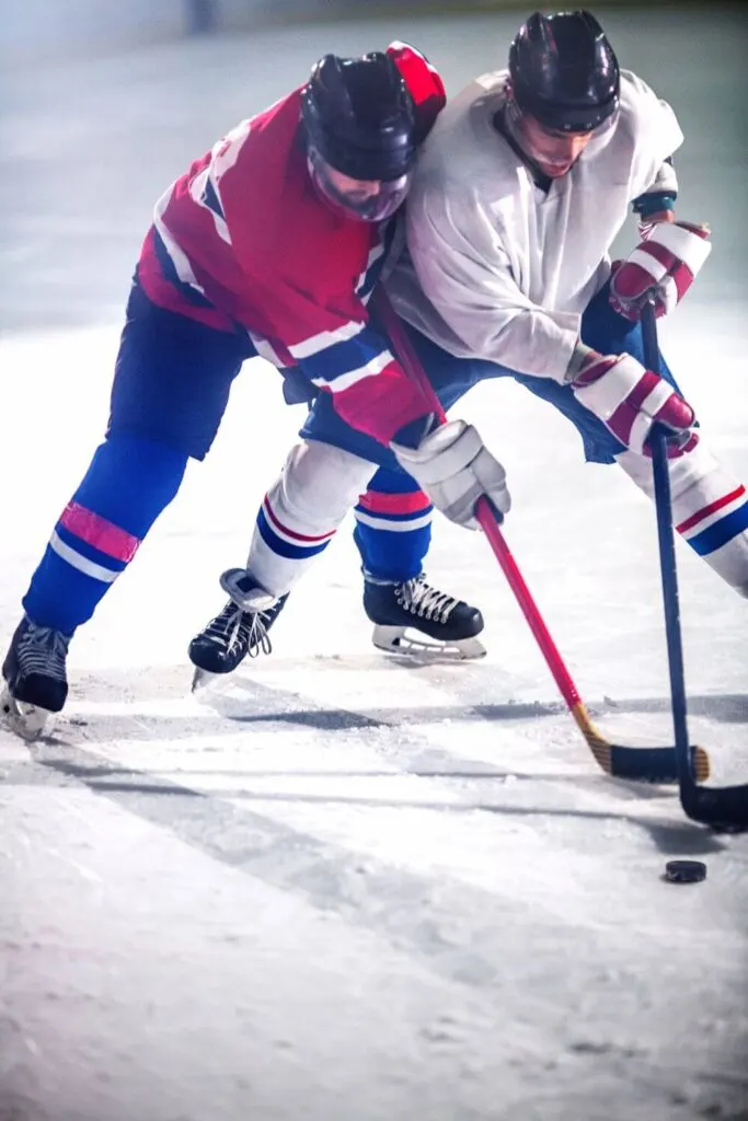 Photo of two men playing ice hockey.