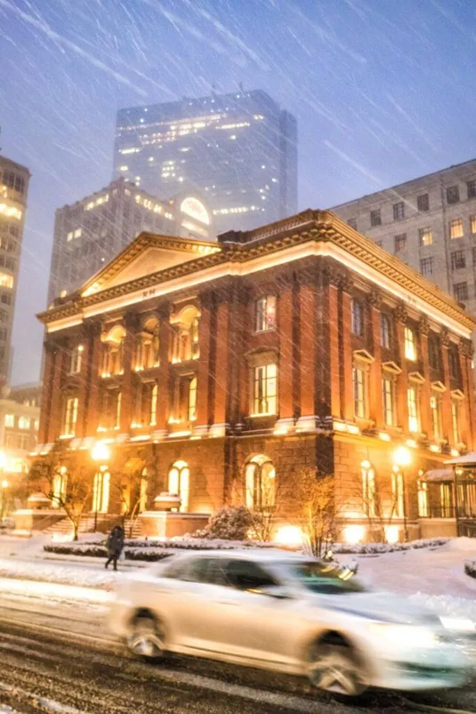 Photo of Newbury Street in Boston at dusk during a snowstorm.